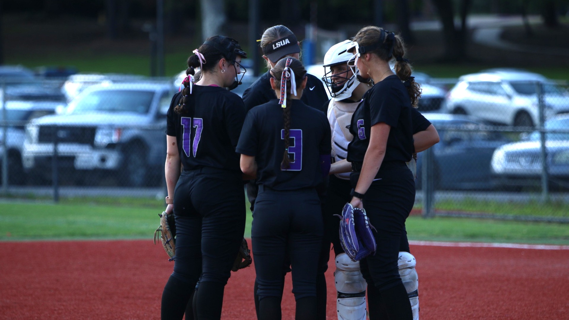 The infield huddles in the circle during a game 