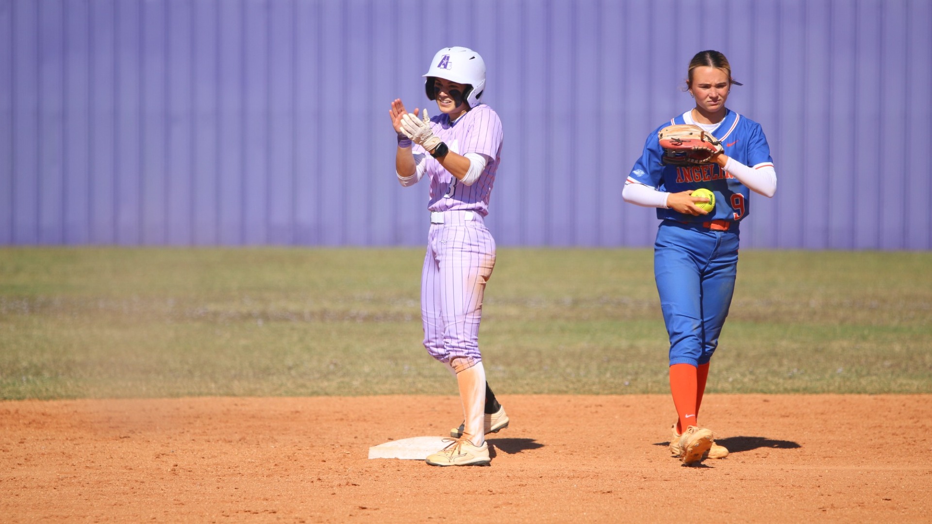 Sophia Romero claps after stealing second during a game