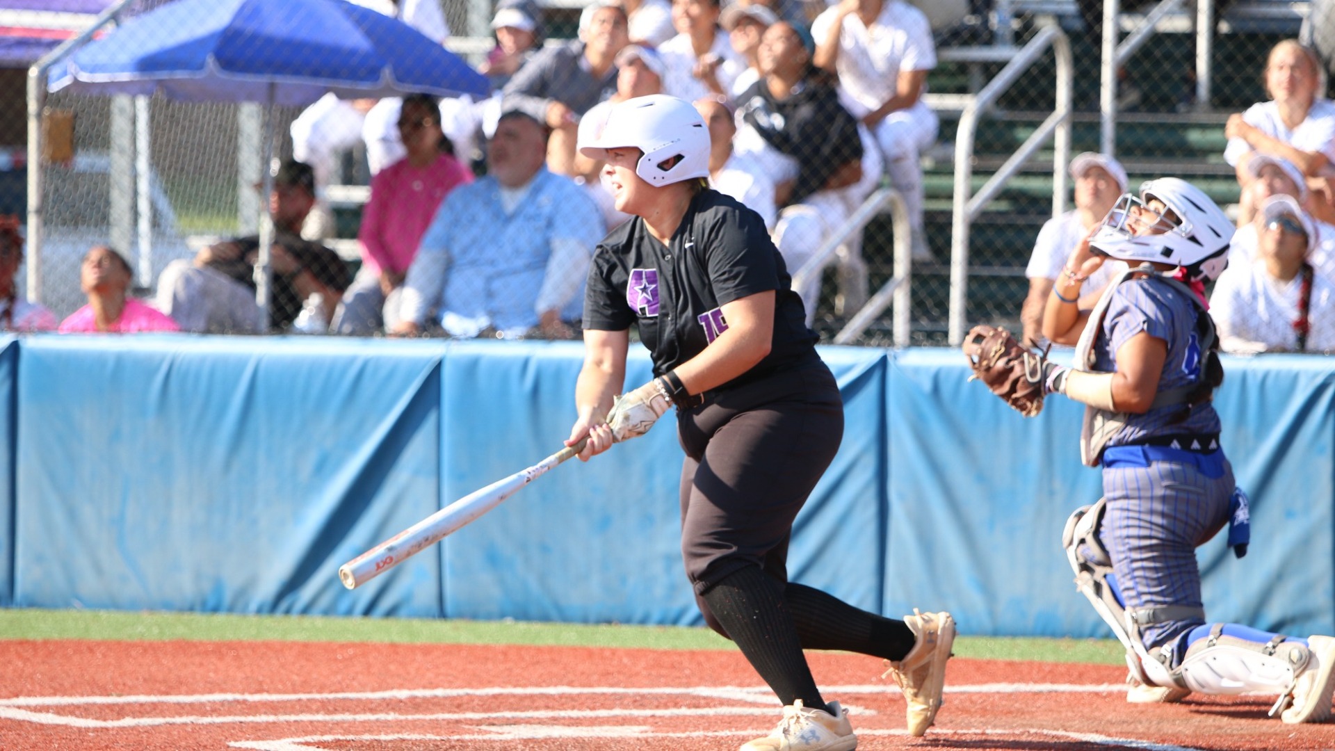 Jillian Howell finishes her swing and prepares to run during a game