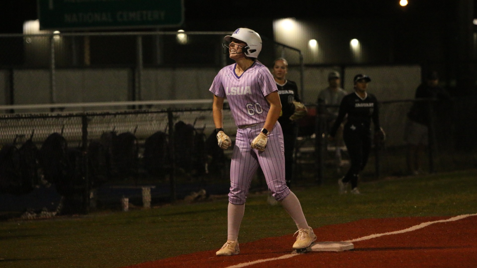 Kilee Moody celebrates toward the dugout after doubling