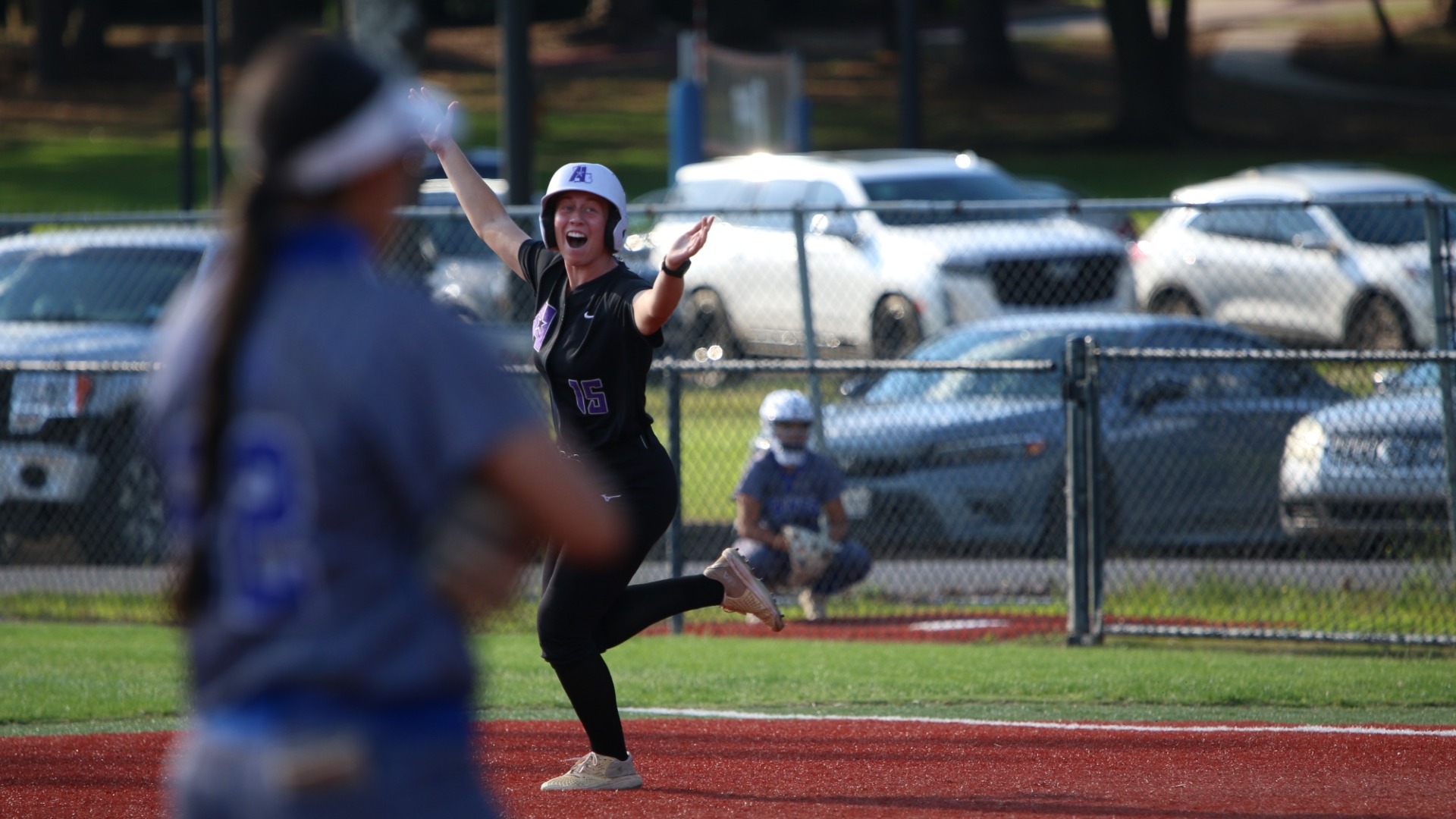 Kaetlyn Dunbar celebrates as she rounds the bases after hitting a grand slam
