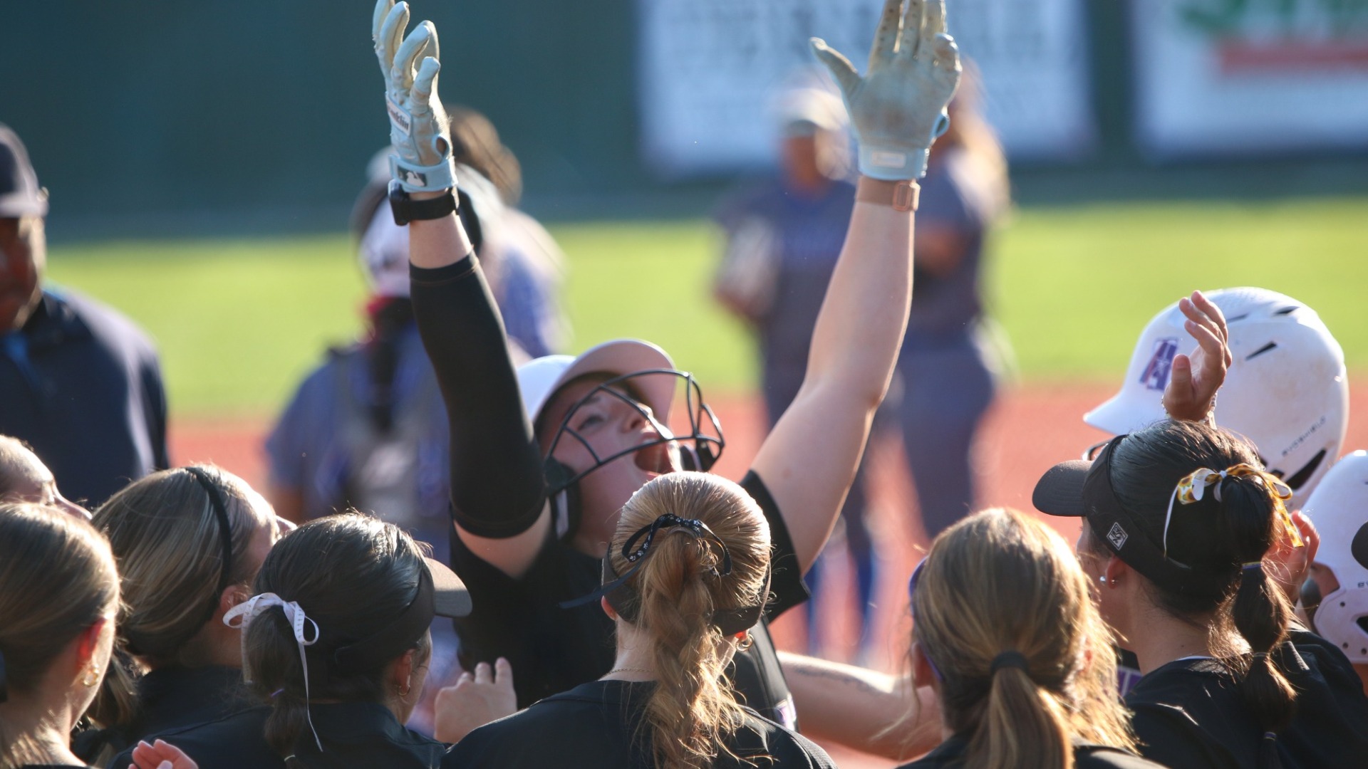 Haley Fontenot celebrates at home plate with teammates after a home run