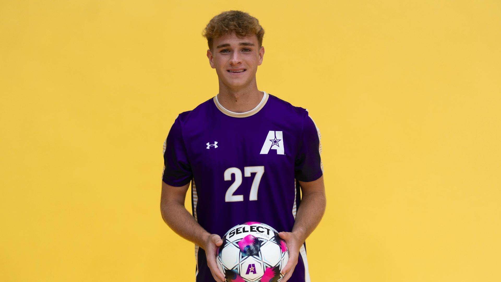 Luke Brown holds a ball on Media Day