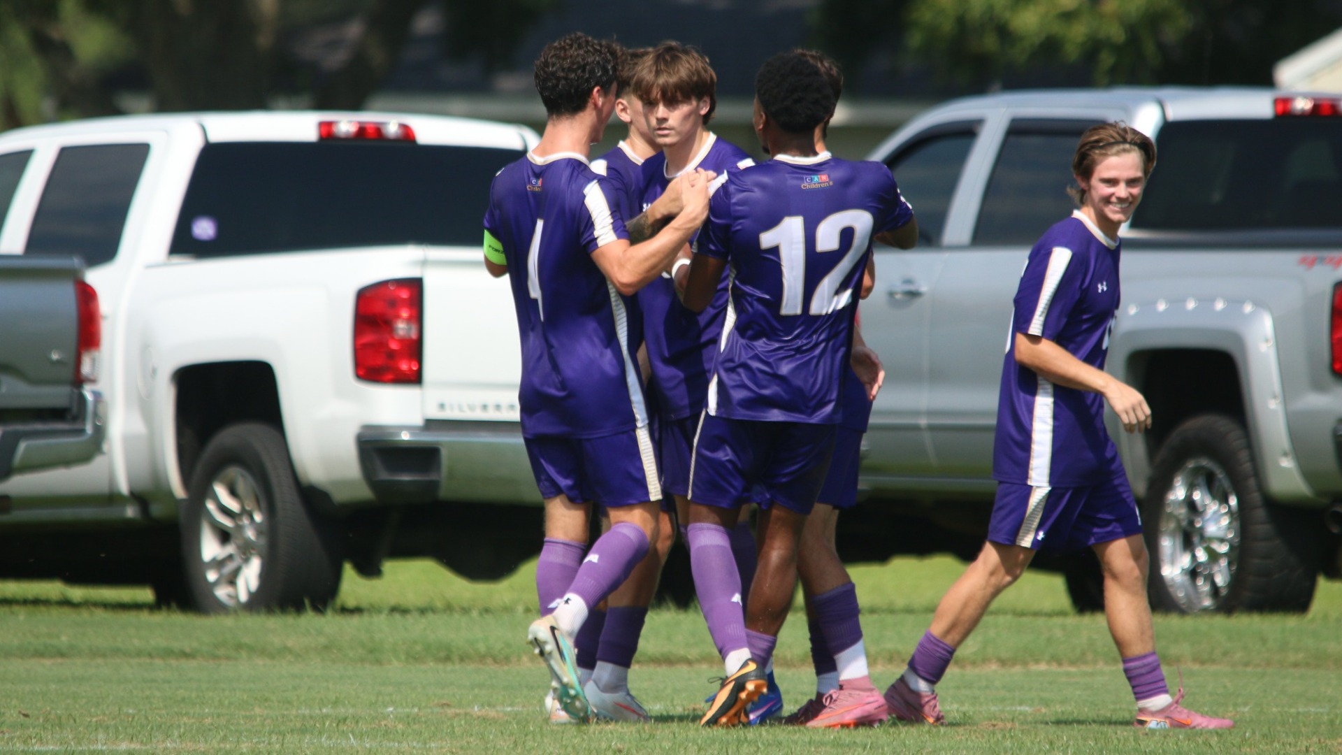 Ben McCarron celebrates with teammates after scoring against Texas Wesleyan