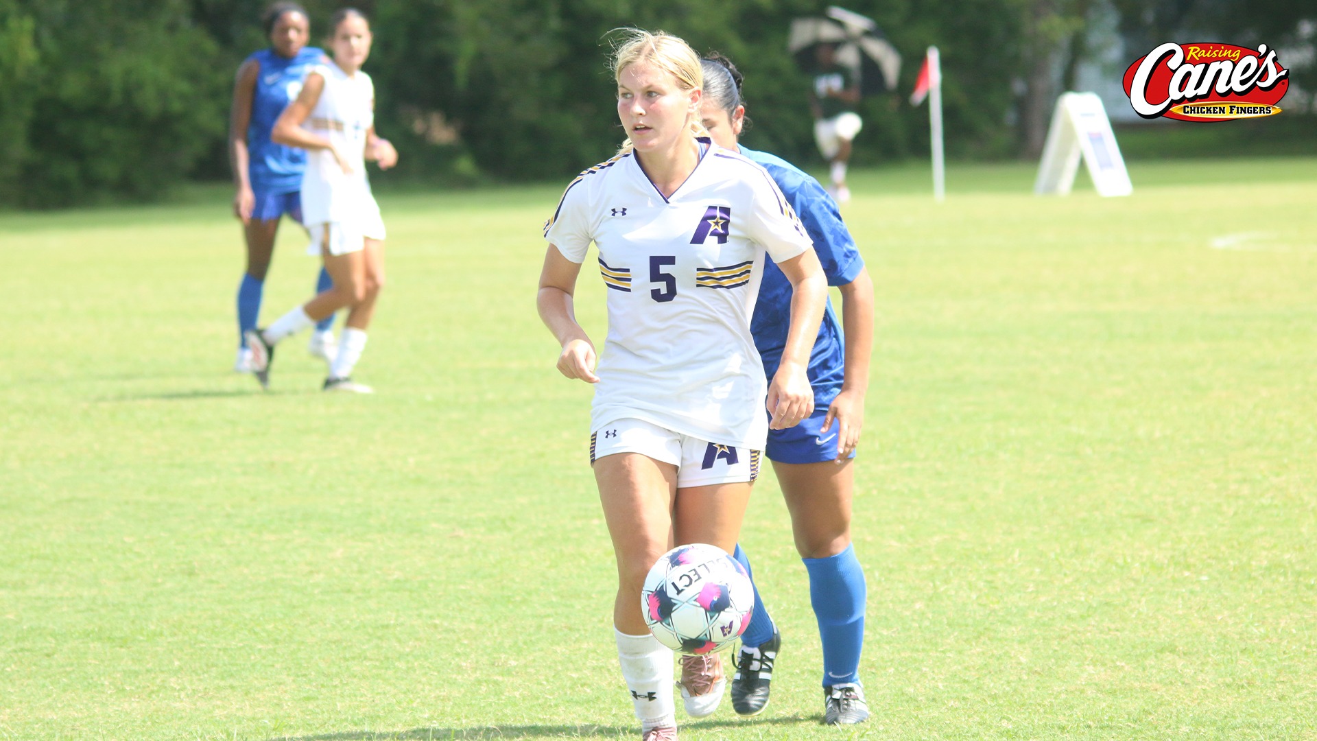 Ava Little dribbles away from a defender 