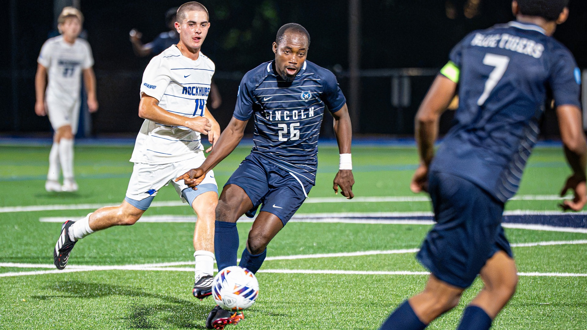 Jonathan Nemorden passes the ball to Makwe Nkoana in Lincoln's road victory at Rockhurst.