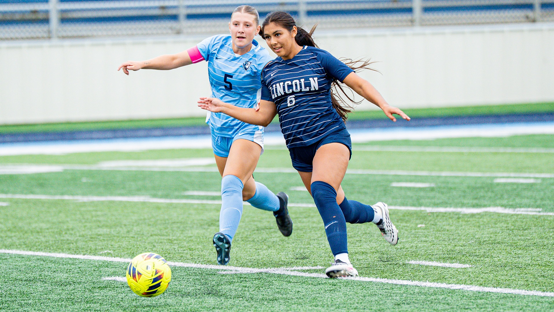 Leah Serritos dribbles past an Upper Iowa defender in a road match in 2026.