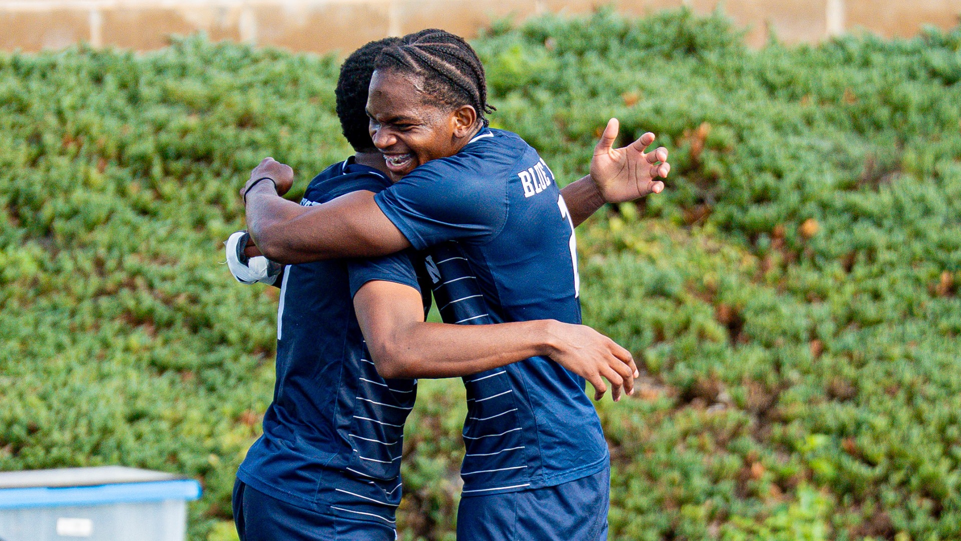Members of the Lincoln men's soccer team hug after a goal in a 2026 road match.