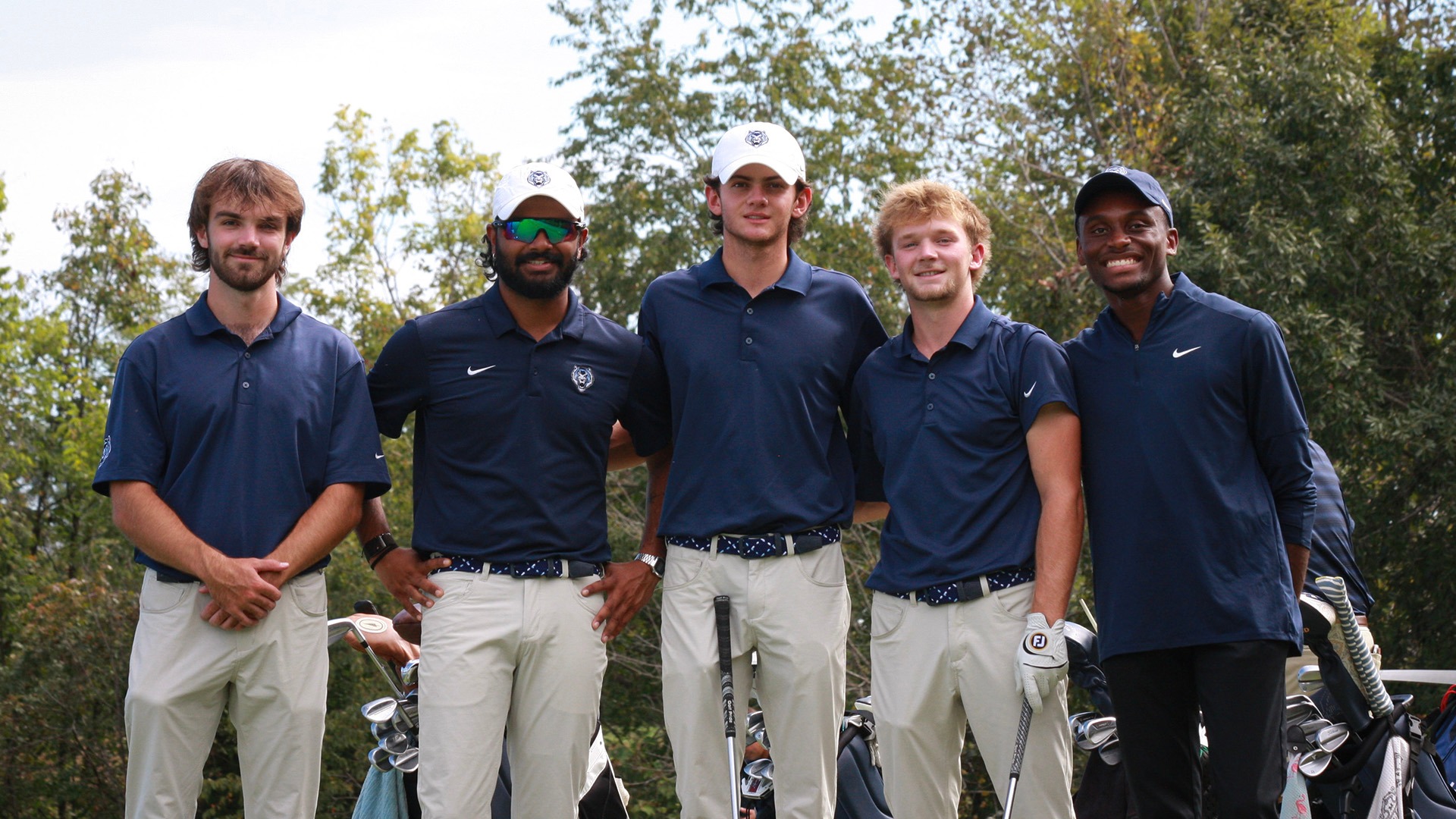 Members of the Lincoln men's golf team pose for a group photo in between holes of a tournament in the Fall of 2026.