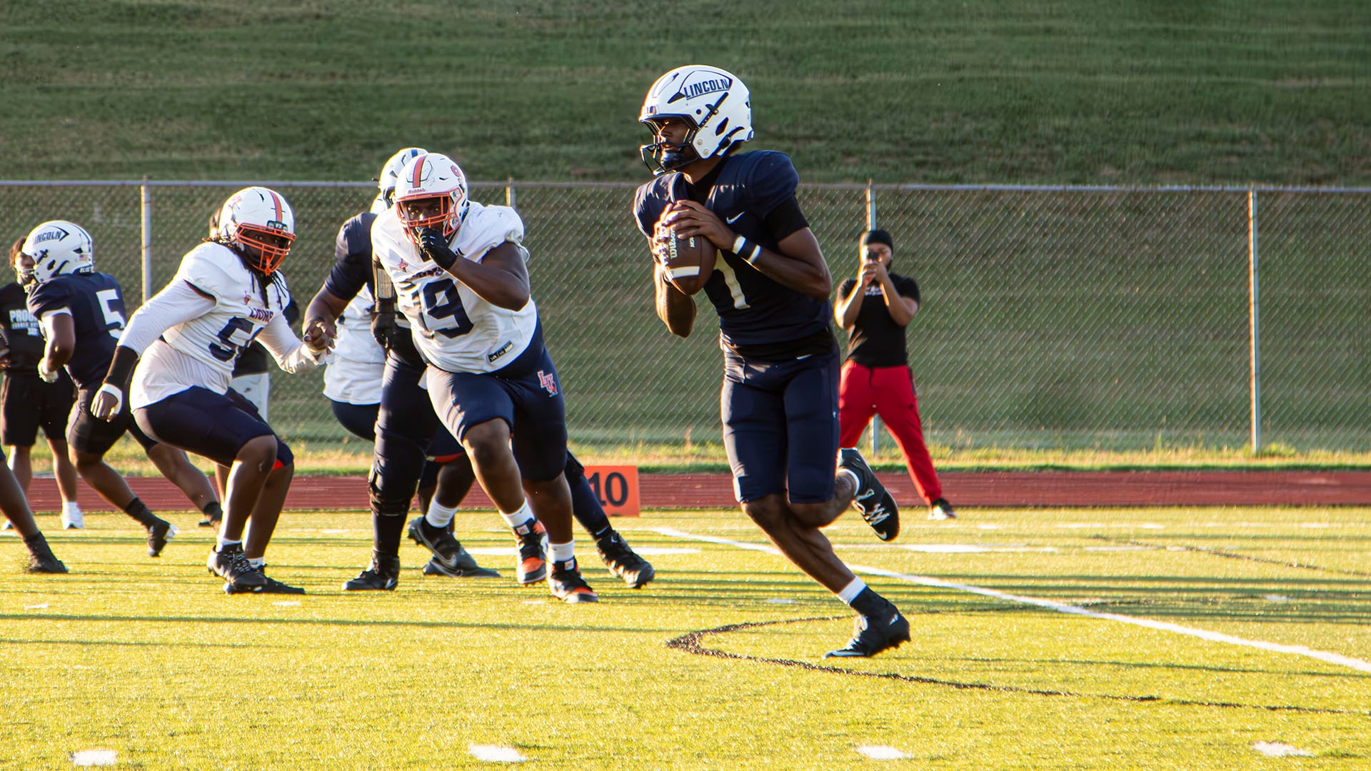 Antwon McKay, Jr. scrambles while attempting a pass against Langston at Dwight T. Reed Stadium.