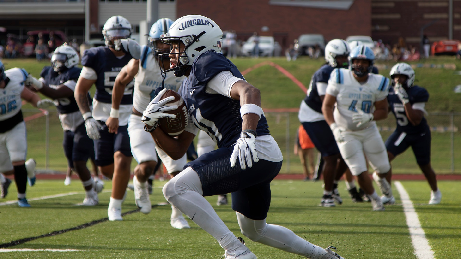 Khylin Arnett races past the Upper Iowa defense for a long touchdown reception in Lincoln's Homecoming win over Upper Iowa.