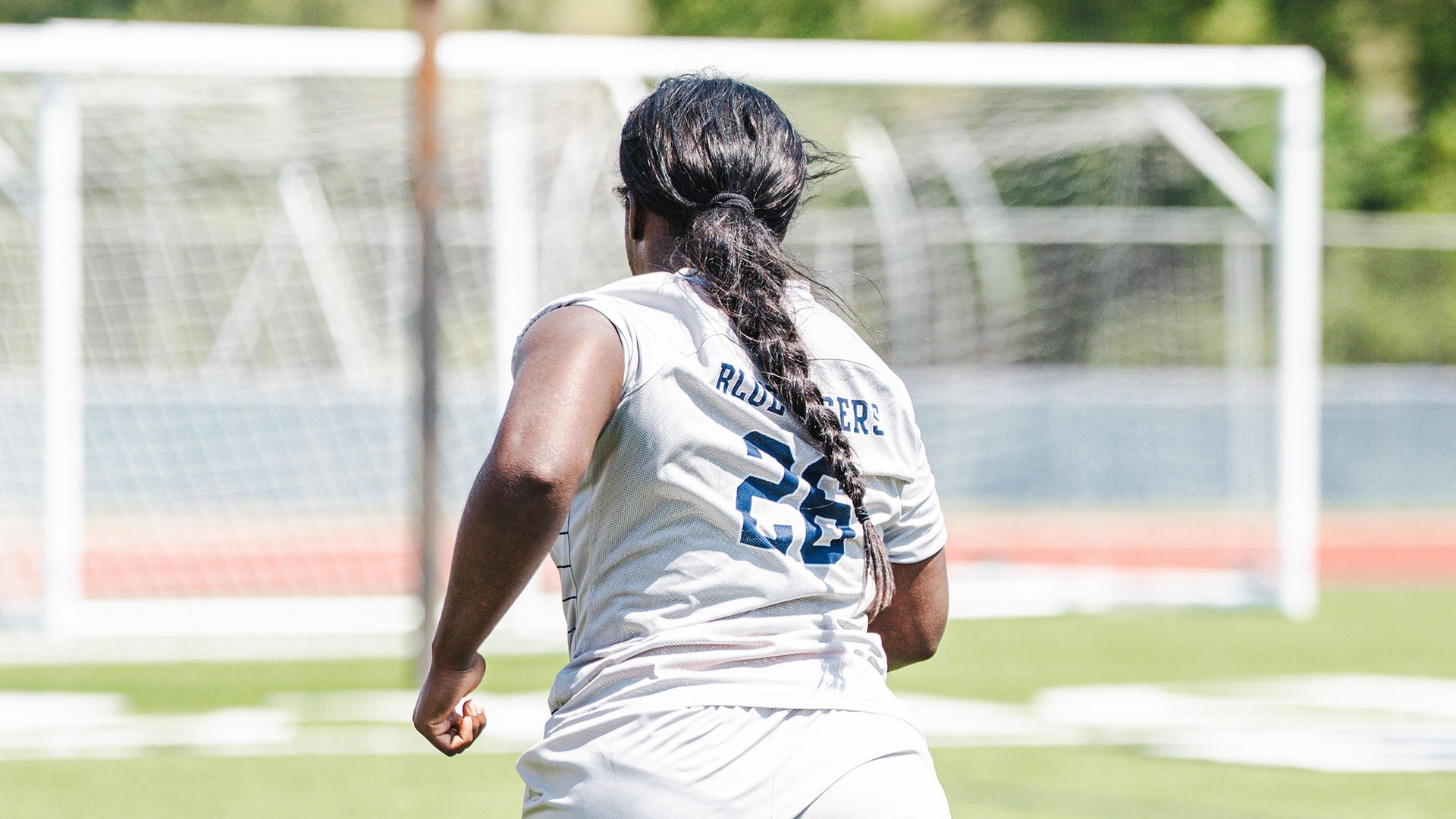 TeTee Jallah Races Toward the Net in a Home Match Against Harris Stowe.
