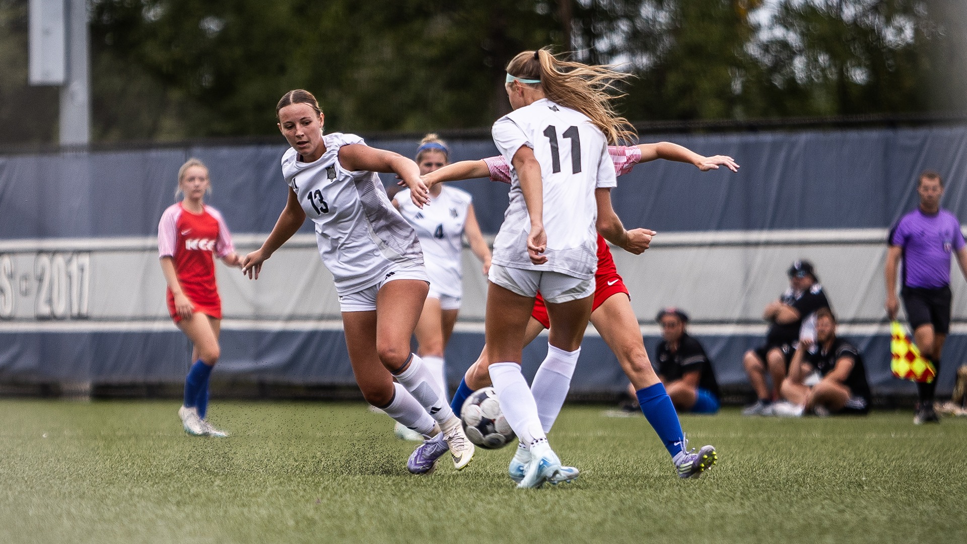 Emmy Troup controls the ball surrounded by others