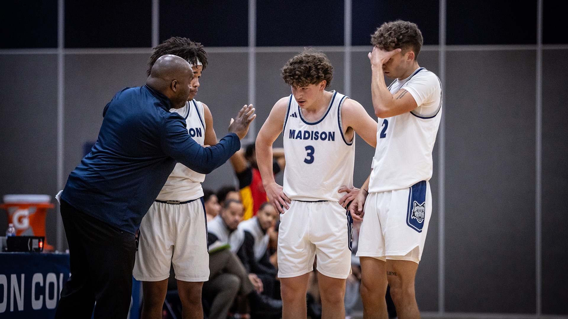 Coach Roscoe chats with backcourt players George Whaley, Carson McCormick, and Braylen Blue