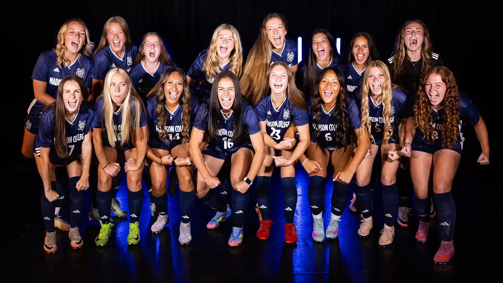 The 2025 women's soccer team flexes their muscles and shouts