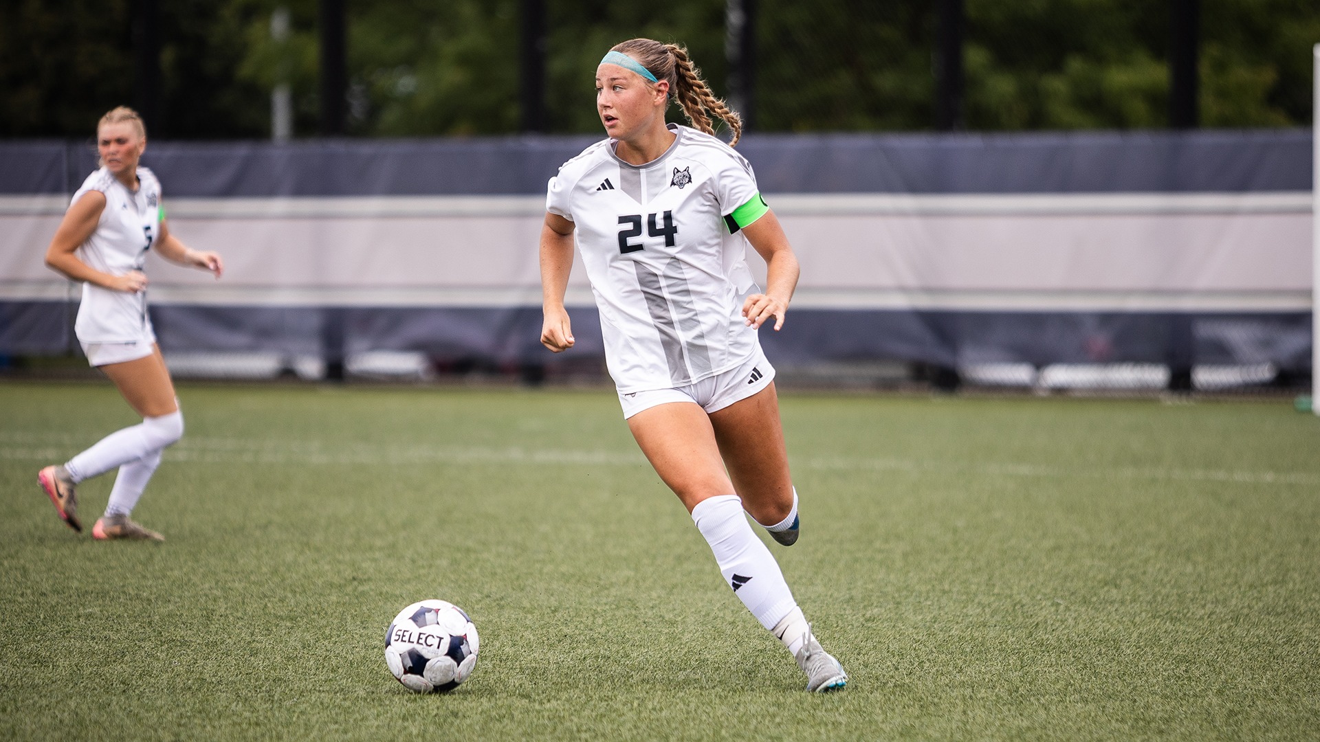 Emmy Coe Troup dribbles the ball up the field while looking for a teammate.