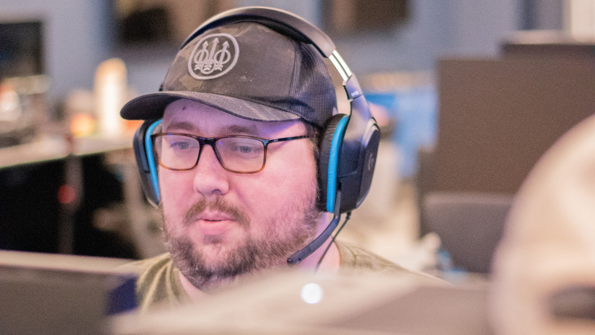 Esports player wearing a headset and looking at a screen