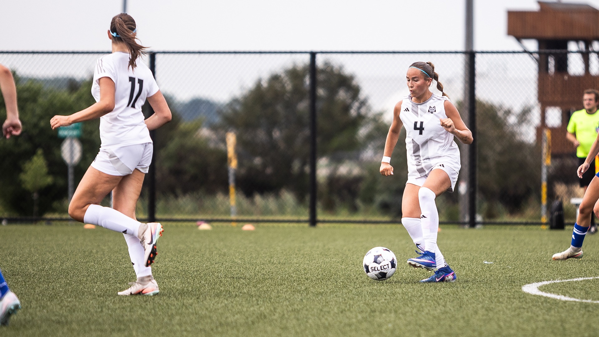 Maddie Ludwig works the ball up the field as teammate Roos Zwolschen runs alongside.