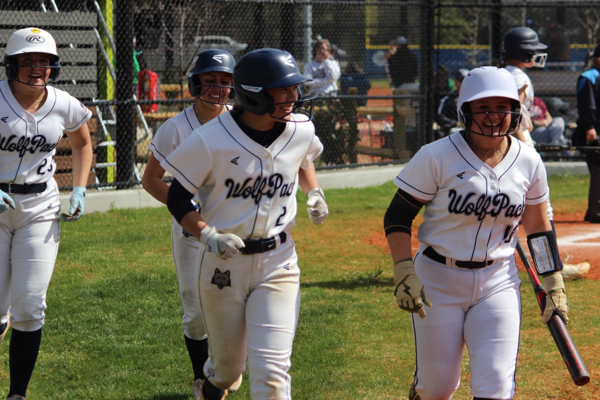 Haleigh Benish and Sadie Svendsen celebrate with teammates after scoring