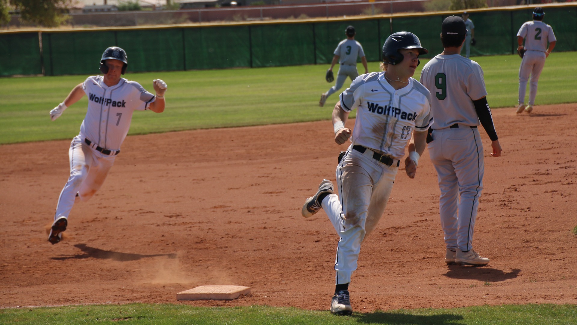 Nate Novinska and Sam Moses race around third base