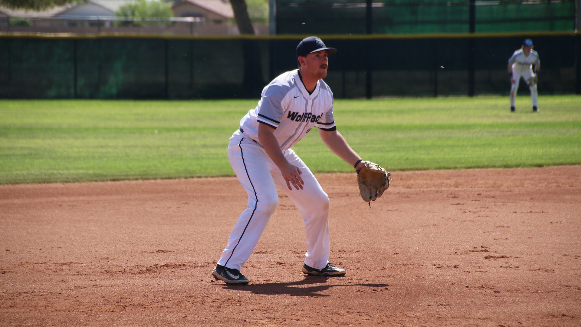 A Madison College baseball player gets ready at third base.