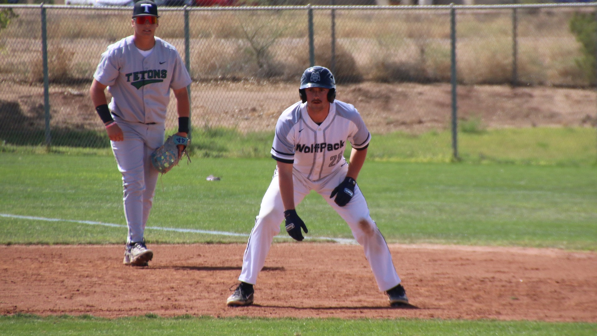 Eason Hurd leads off a base while a defender looks on