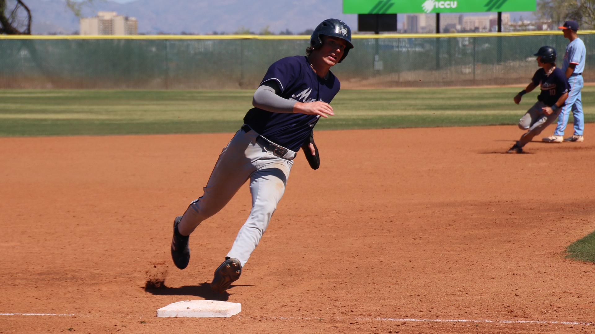Quinn Falish rounds third base as teammate JJ Wolbert rounds second in the background