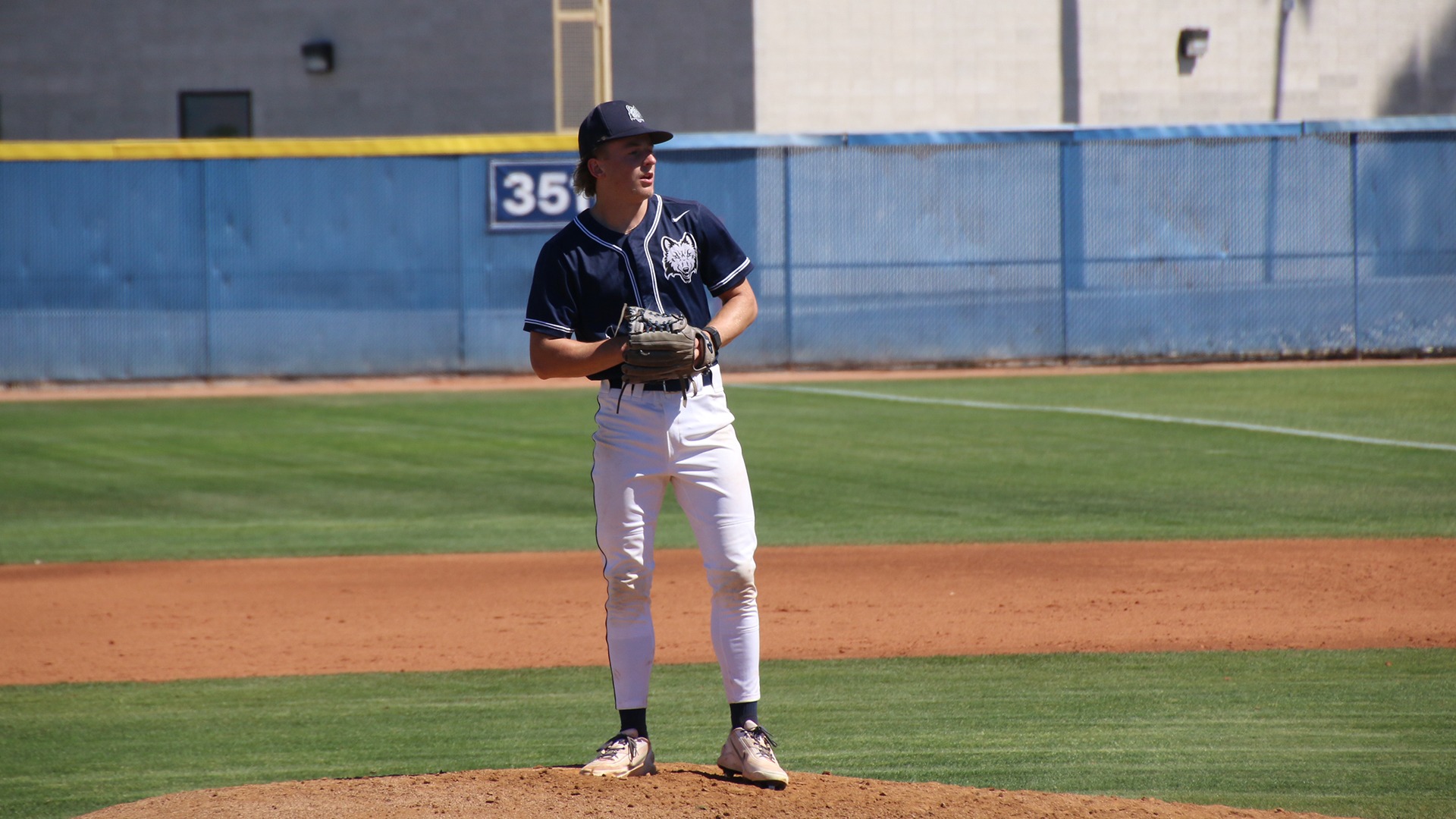 Axel Donaldson stands atop the mound as he prepares to deliver a pitch.