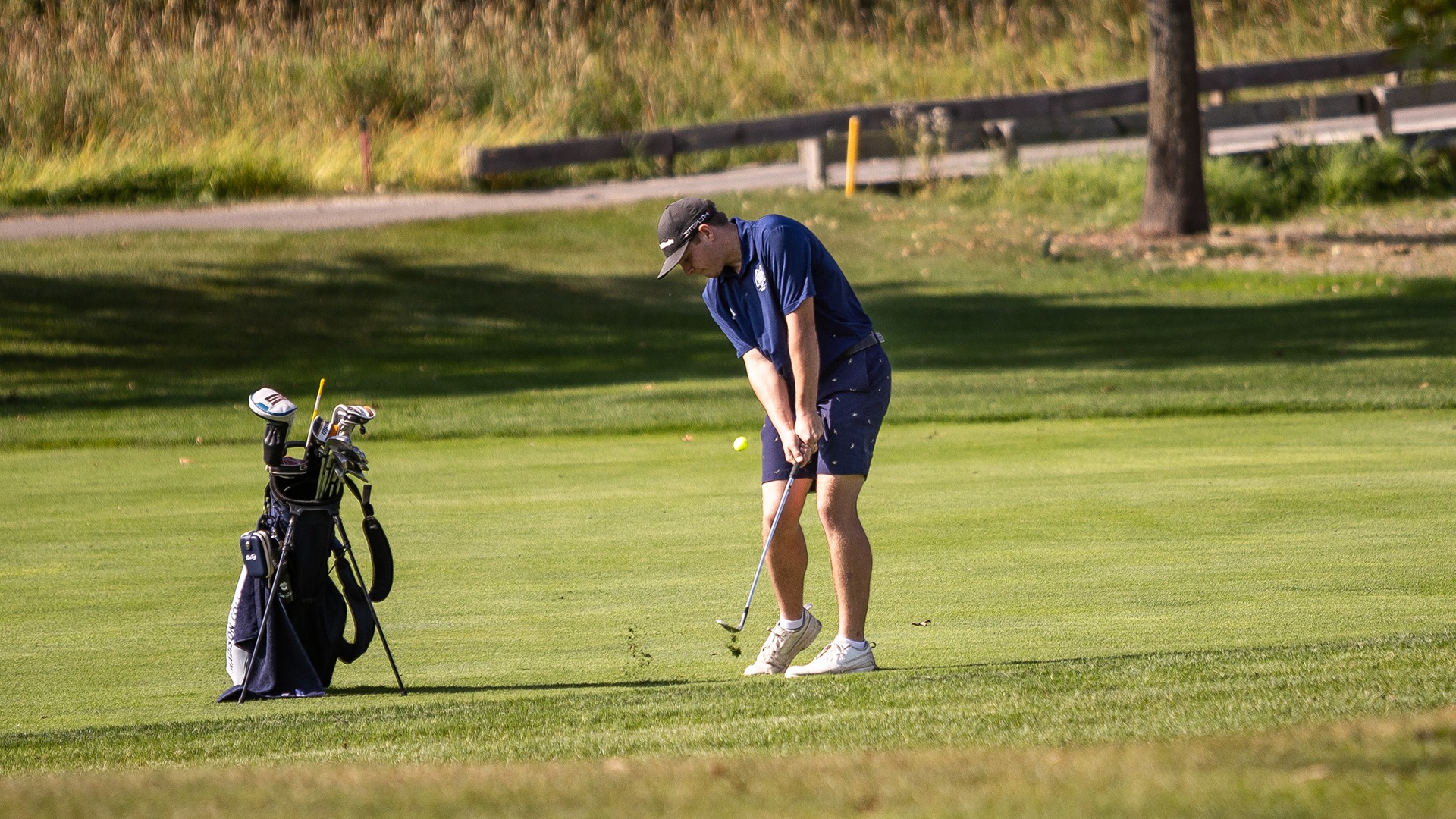 Gavin Davidson hits a shot with an iron as the ball takes fly from the fairway.