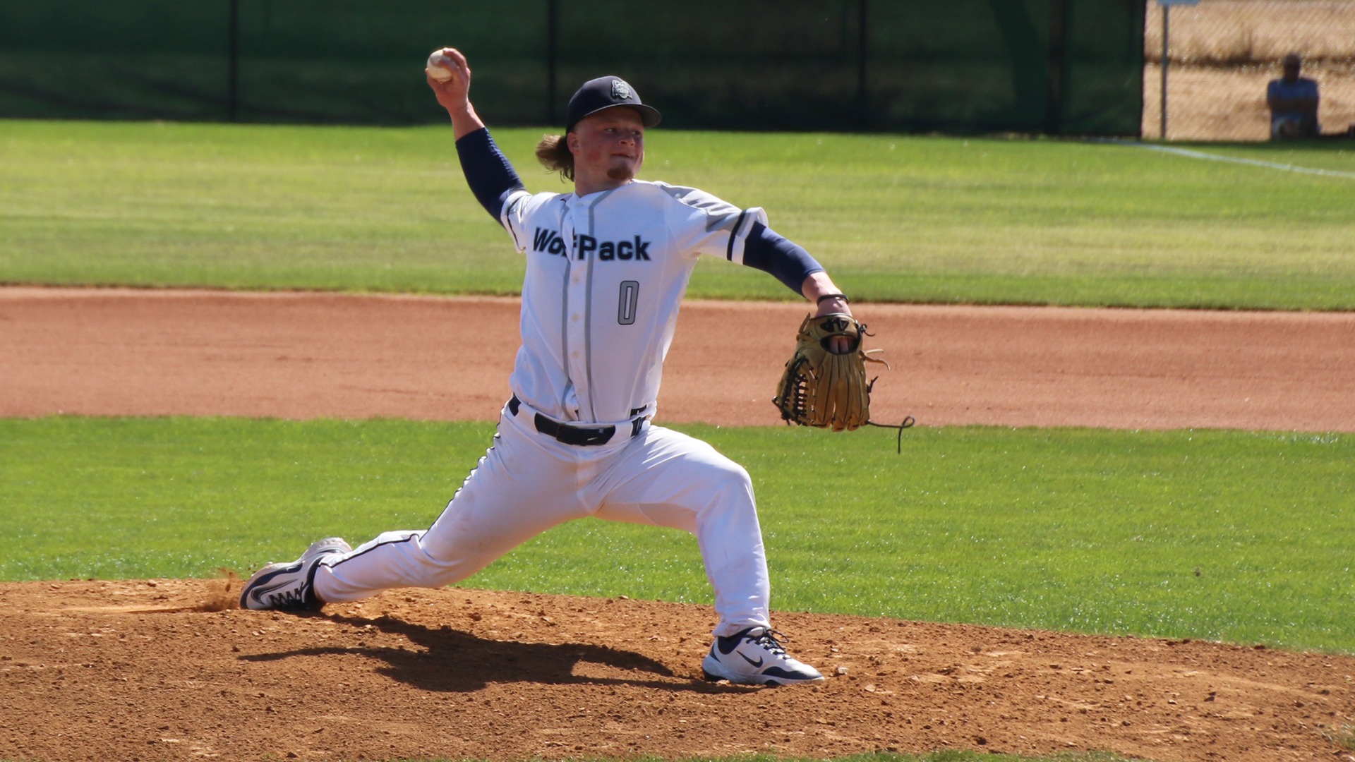 Adison Tevz stretches to deliver a pitch with his right hand.