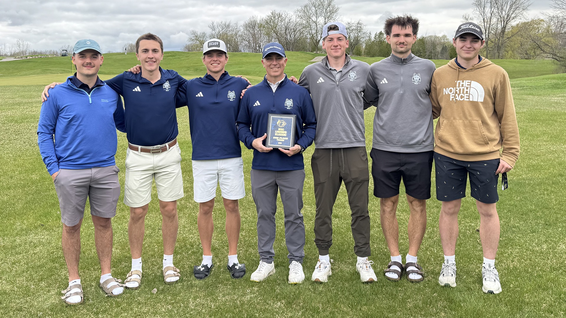 Madison College golf team with coach Chris Soulier poses with the 2nd place plaque at BSC Legends Classic.