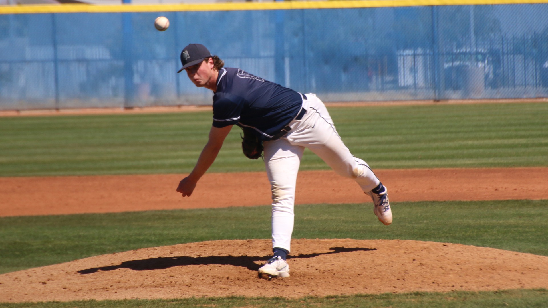 Chase Baker follows through on a lefthanded pitch from atop the pitcher's mound.
