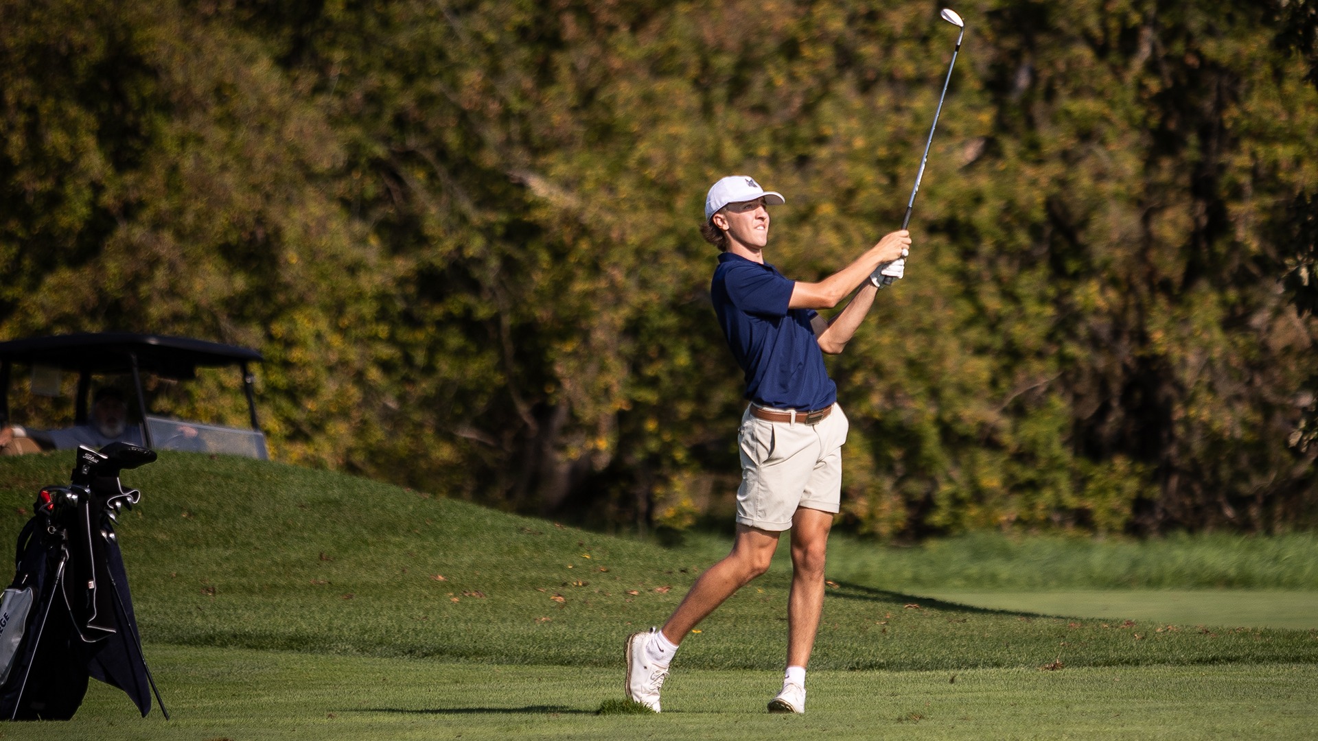 Kellan Jacobson holds his follow throw and watches the ball after hitting an iron shot