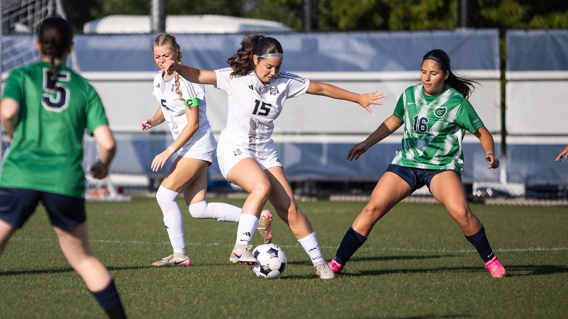 Fay den Hoed dribbles the ball against an opposing team