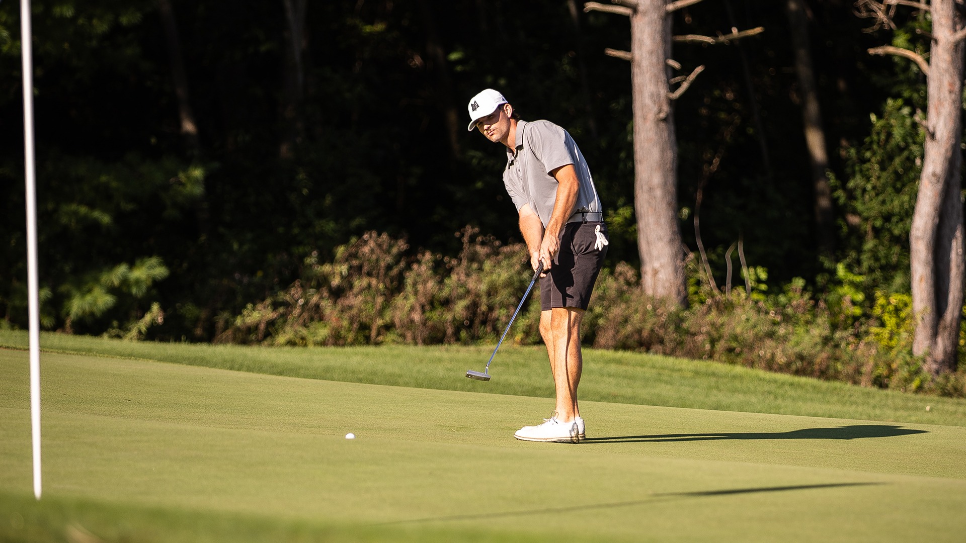 Jacob Schmeltzer watches a putt roll towards the flag