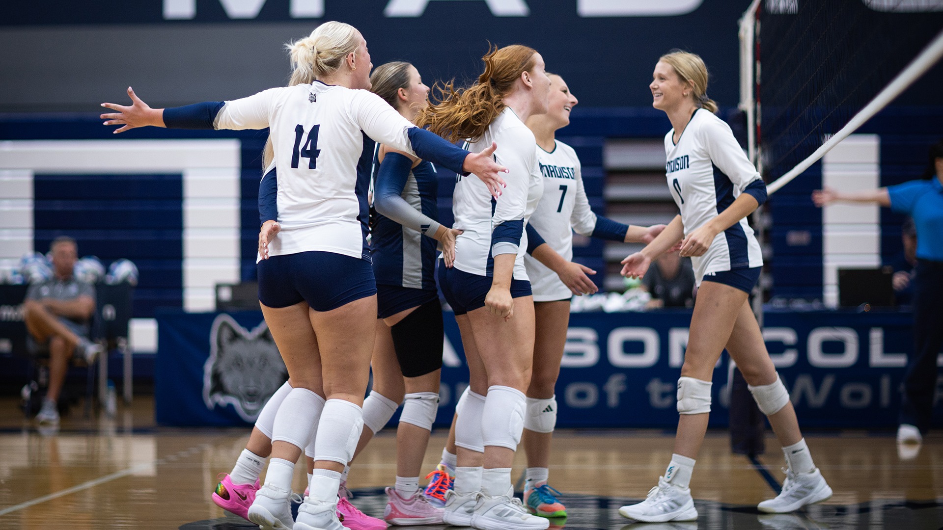 Teammates great and celebrate Cassie Kotlowski after a successful block