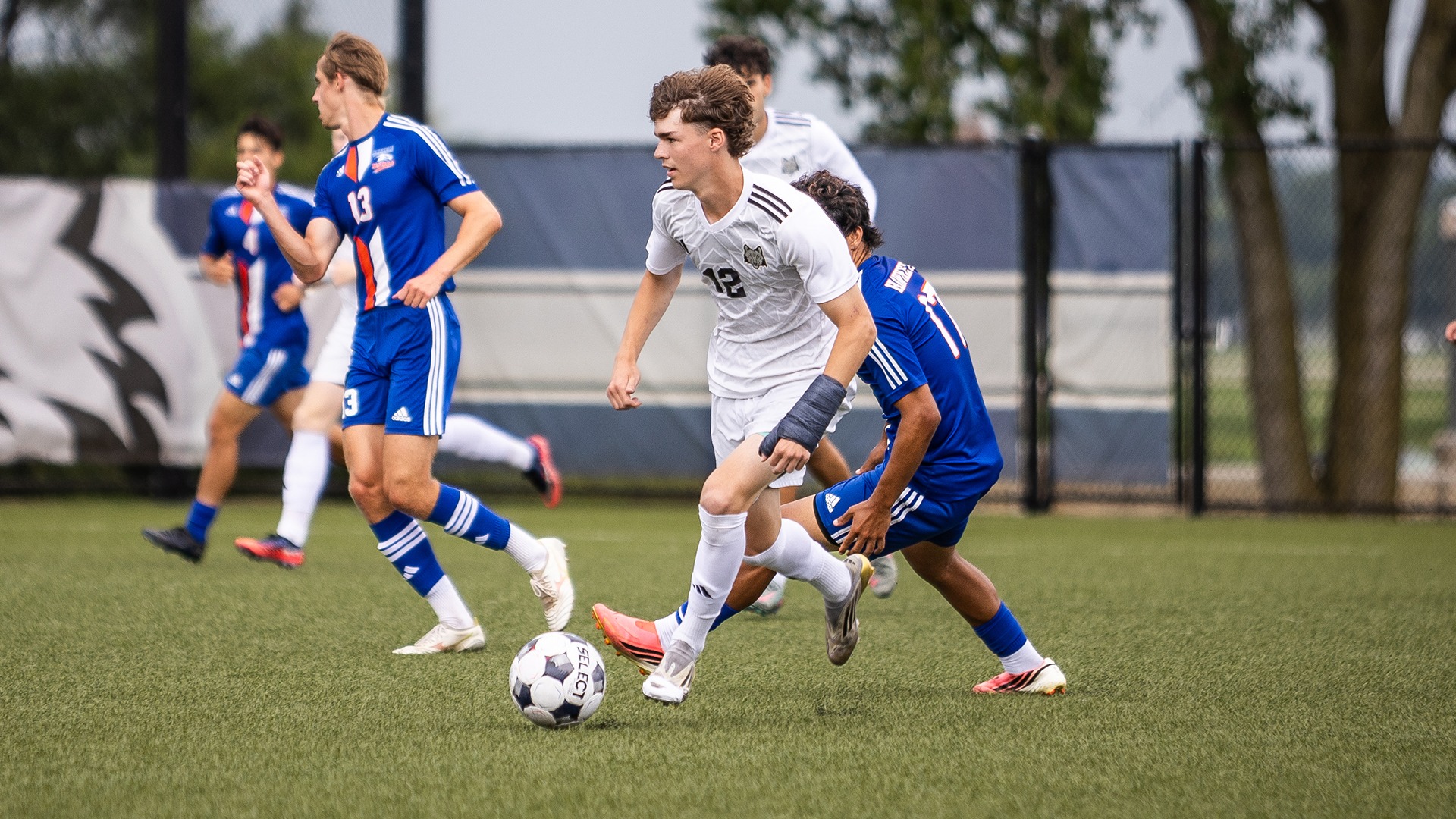 Caden Pullar-Newman dribbles the ball away from defenders