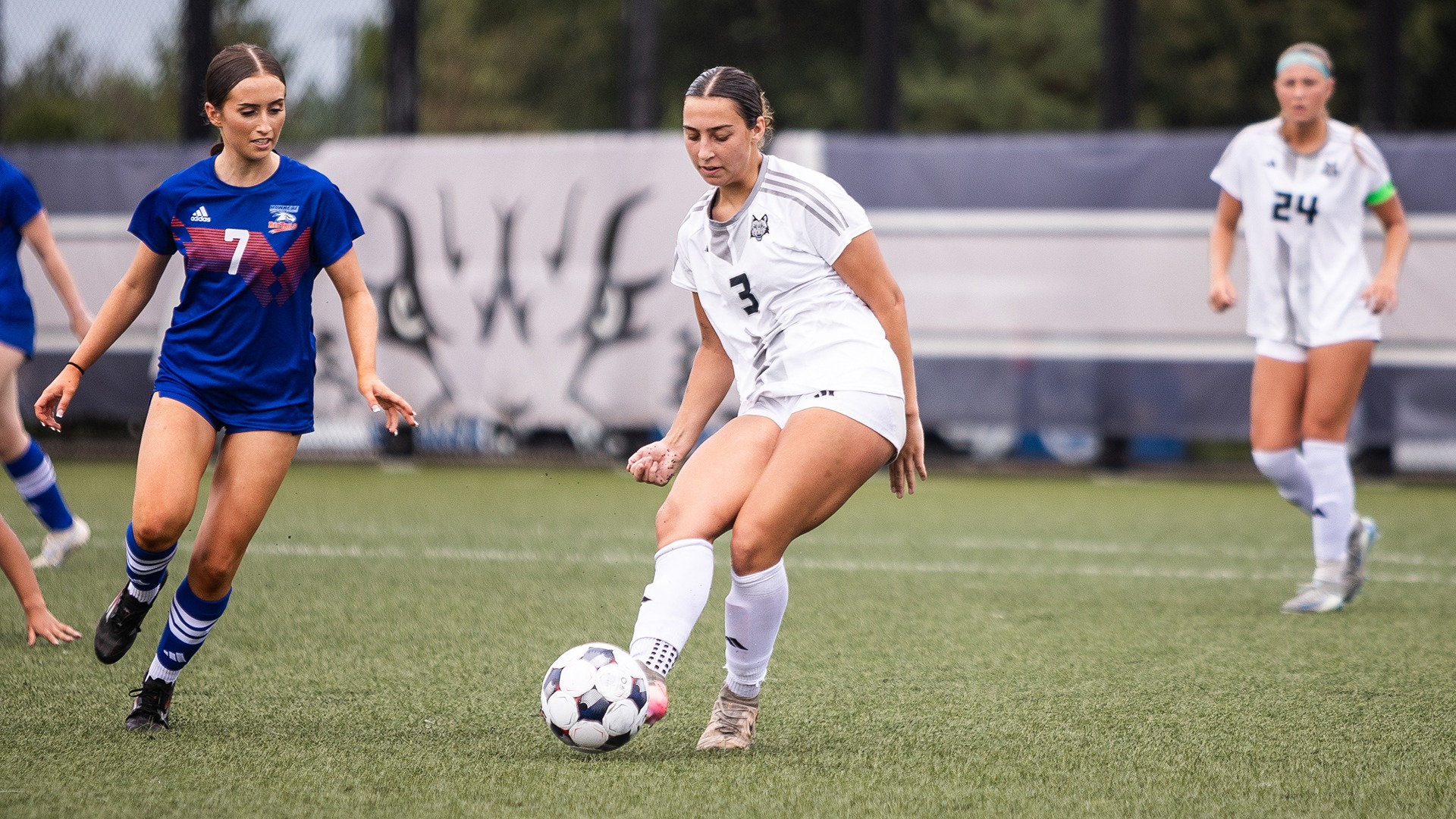 Brenna Uttech passes the ball away from on-coming defenders