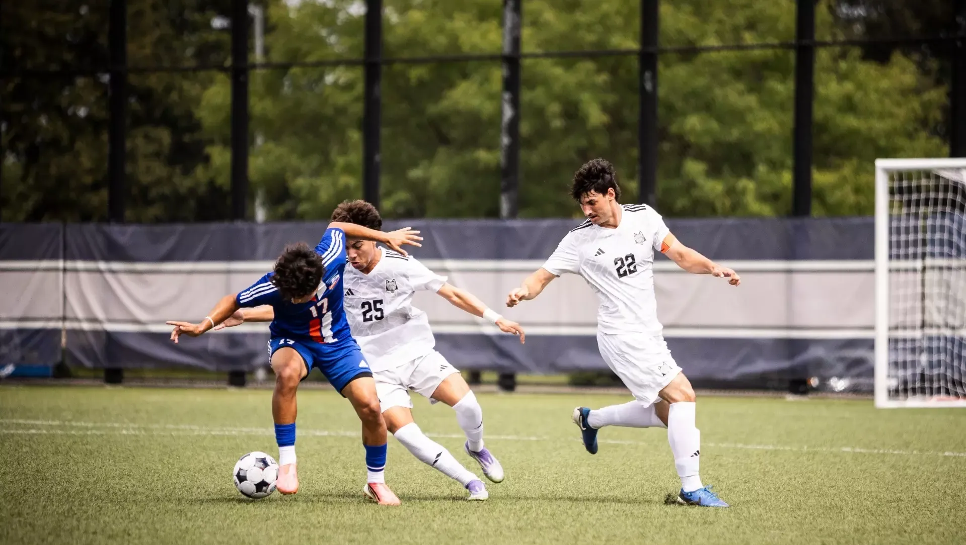 Bryan Hernandez looks to take the ball away from the rival as Will Skinner looks on