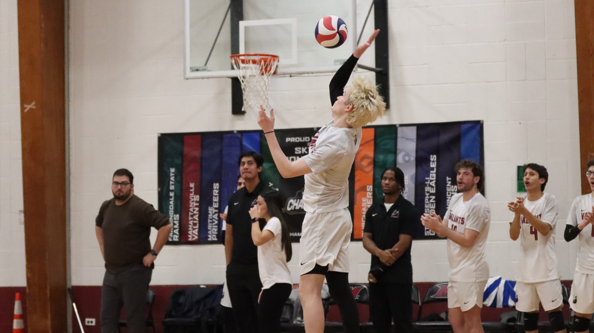 Luca Peterson serves against Sarah Lawrence