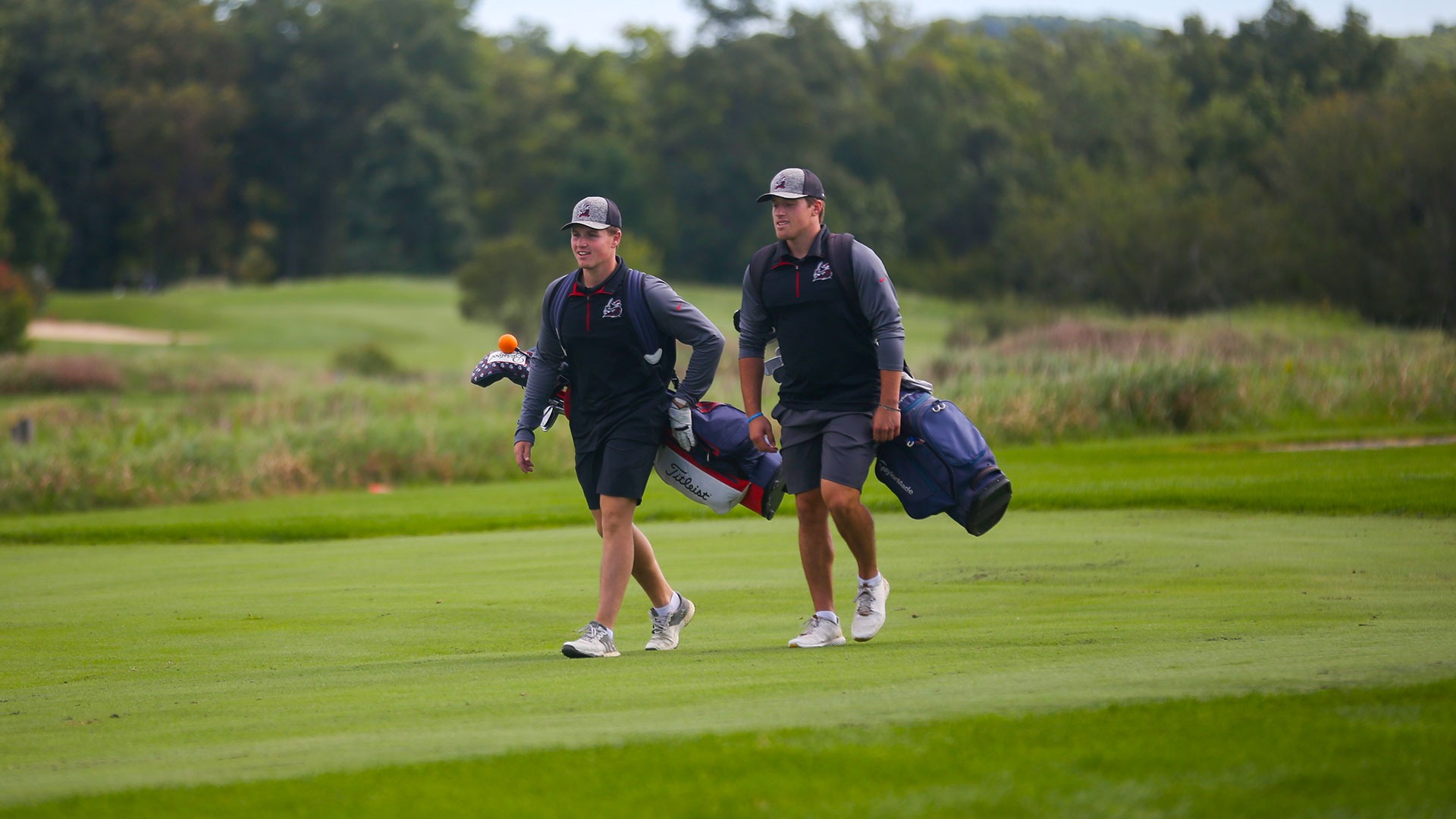 Jack Roberts and Evan Kaloski walking the fairway