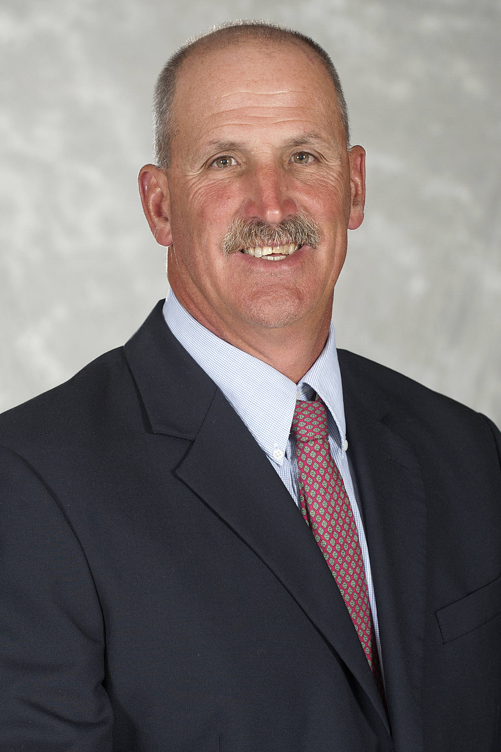 Headshot image of football coach Bill Roos