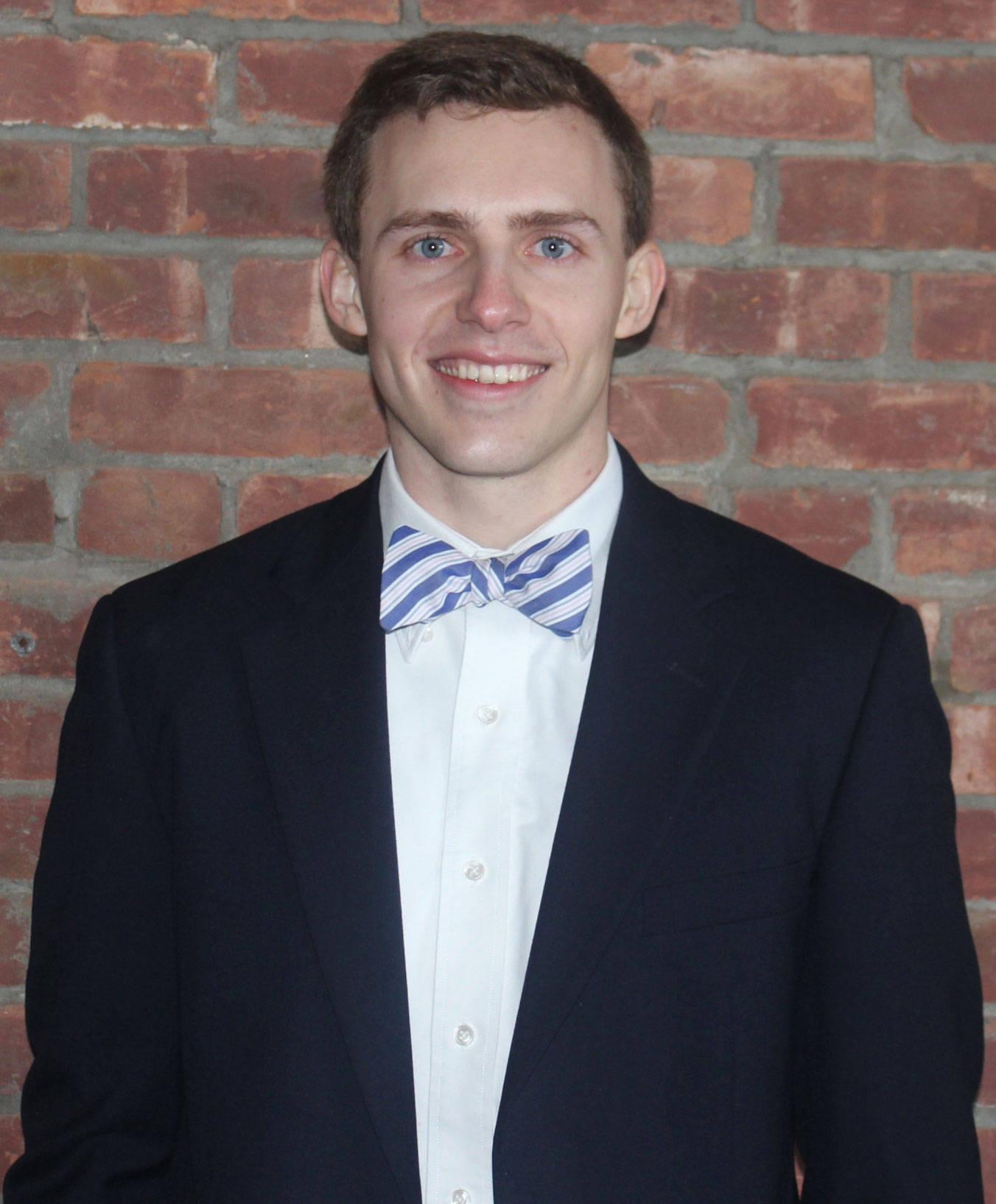 Headshot image of men's rowing coach  coach Ben Smith