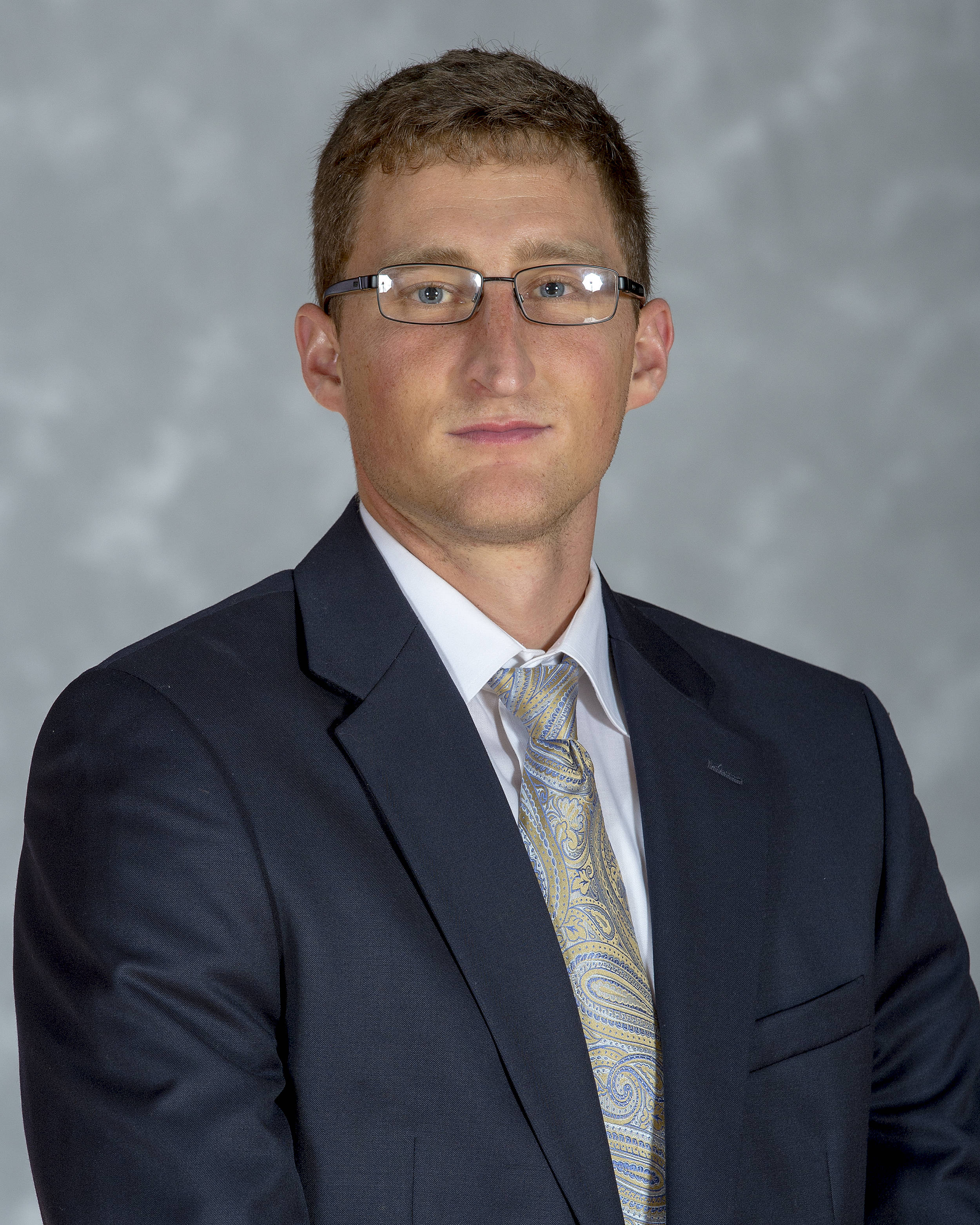 Headshot of men's tennis coach Derek DiFazio