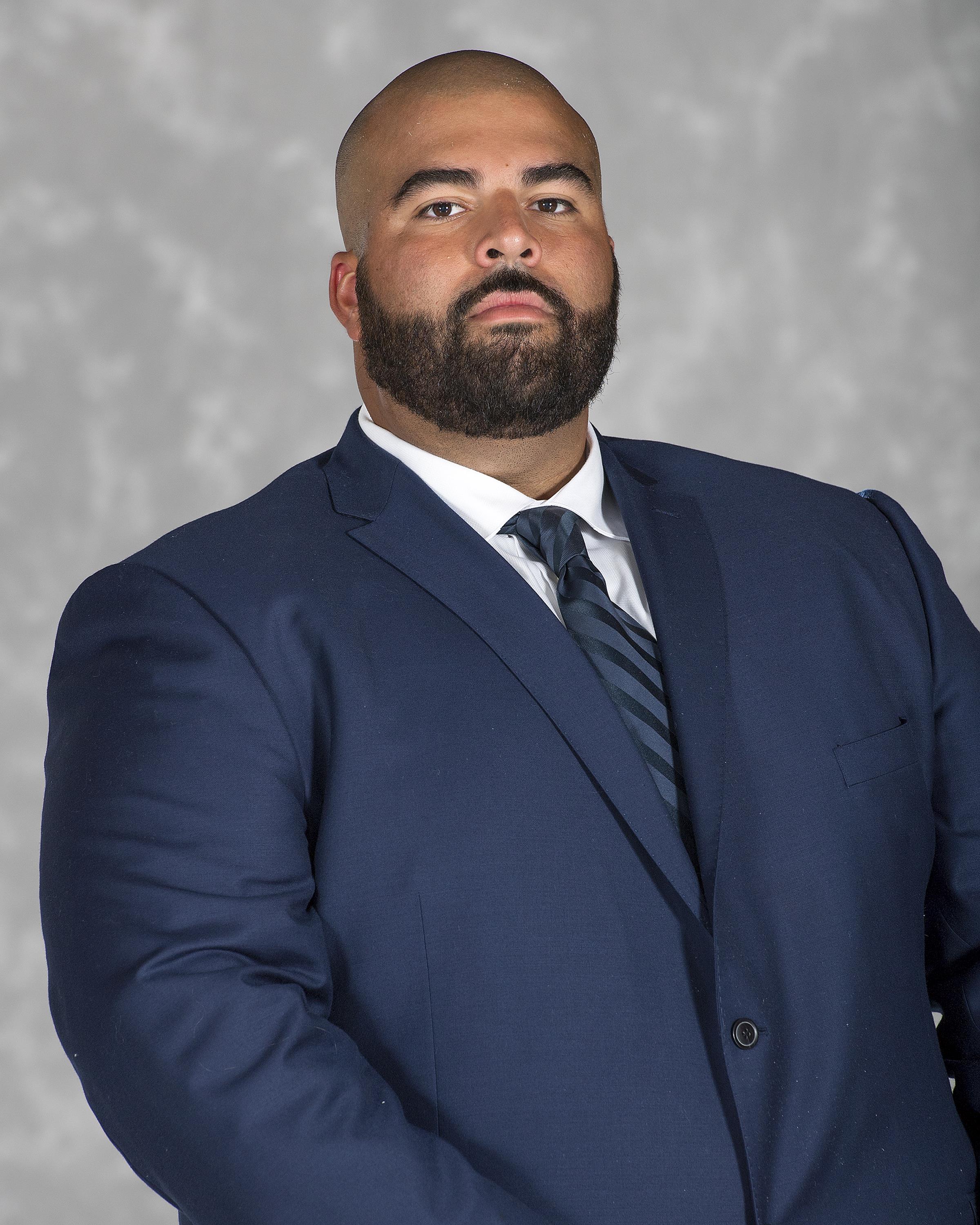 Head shot image of football assistant coach Brandon Cuevas