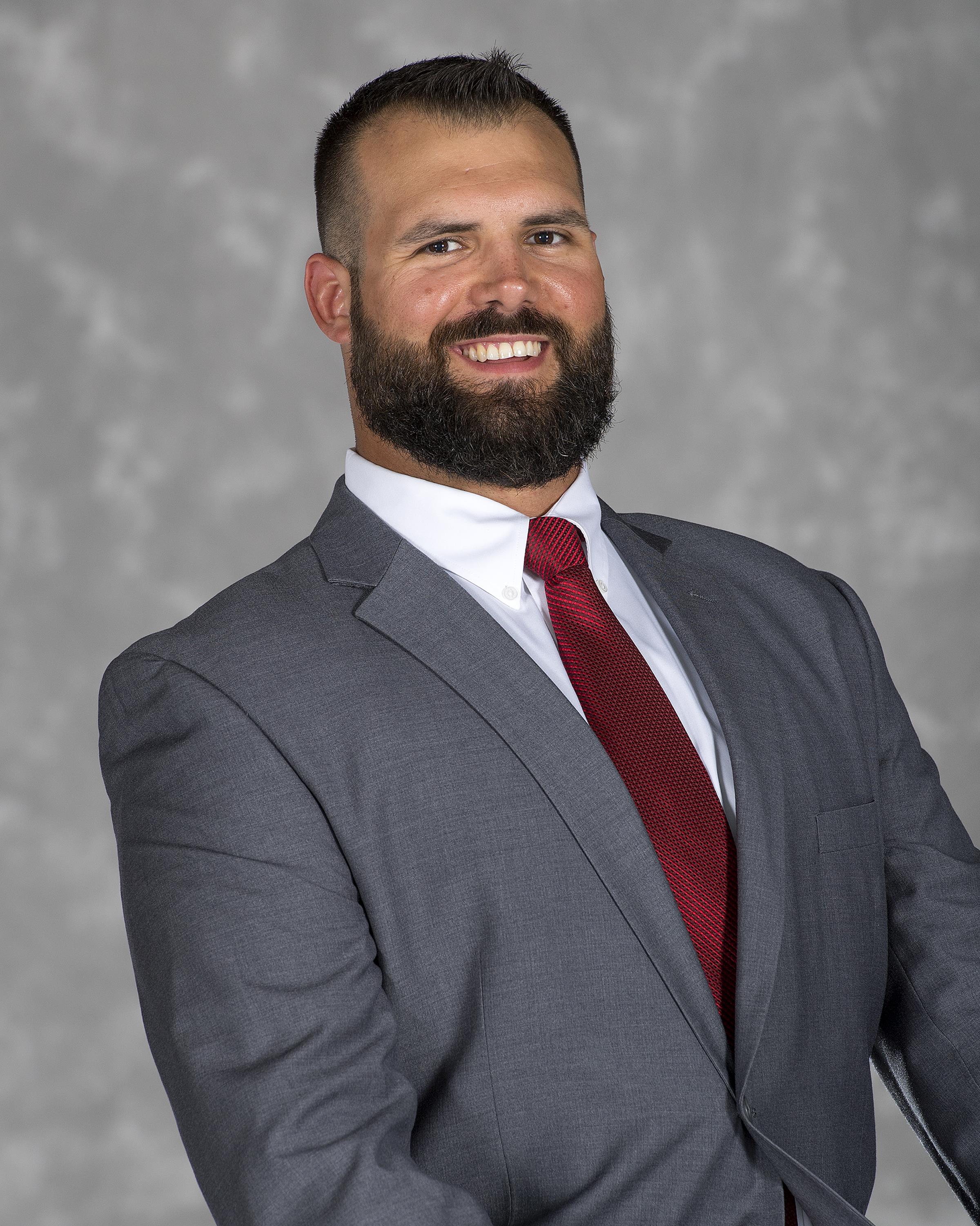Head shot image of football assistant coach Jake Dembow