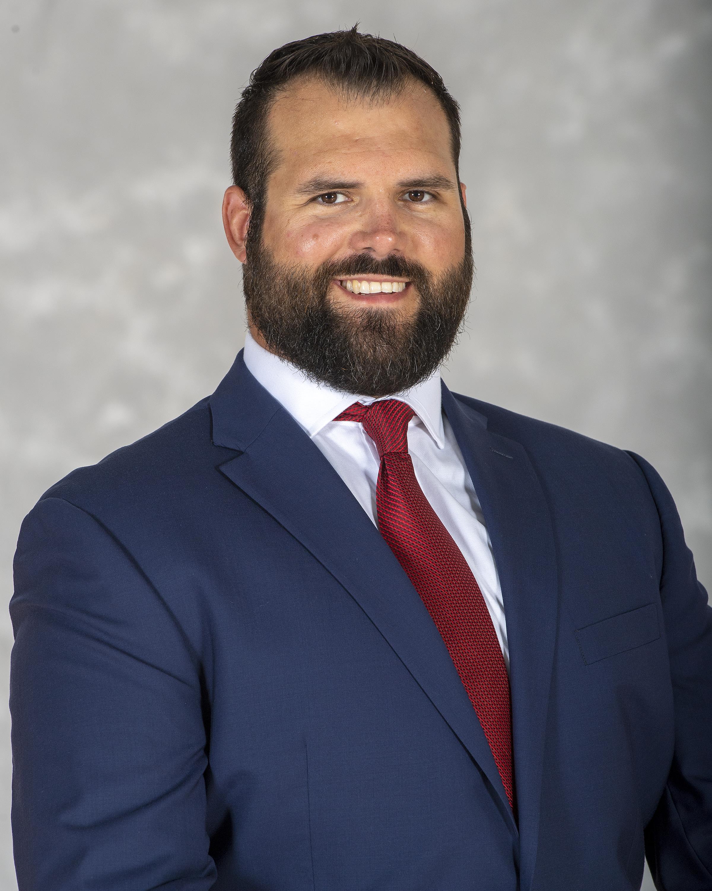 head shot of assistant football coach Jake Dembow