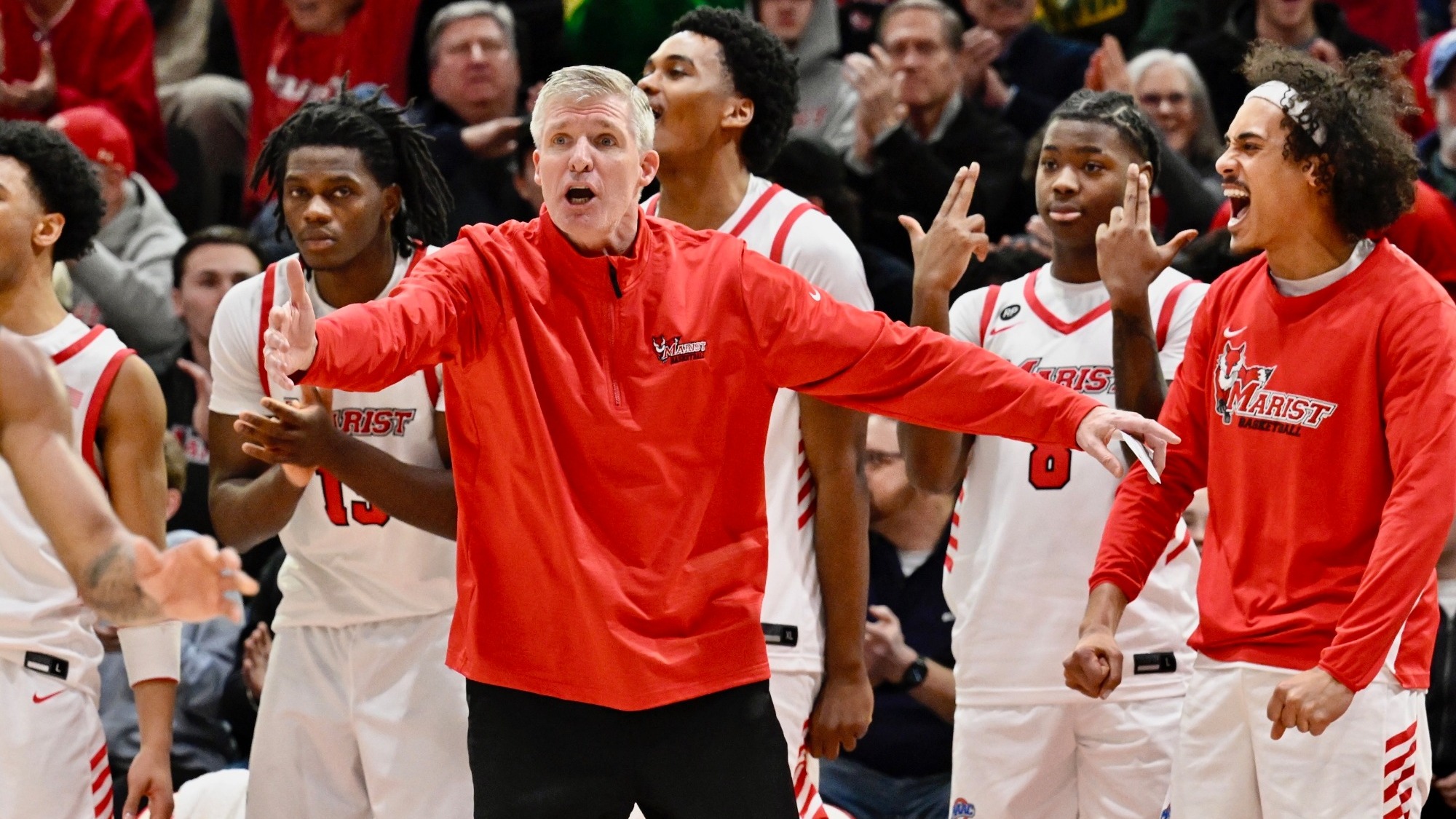 John Dunne and bench celebration - men's basketball