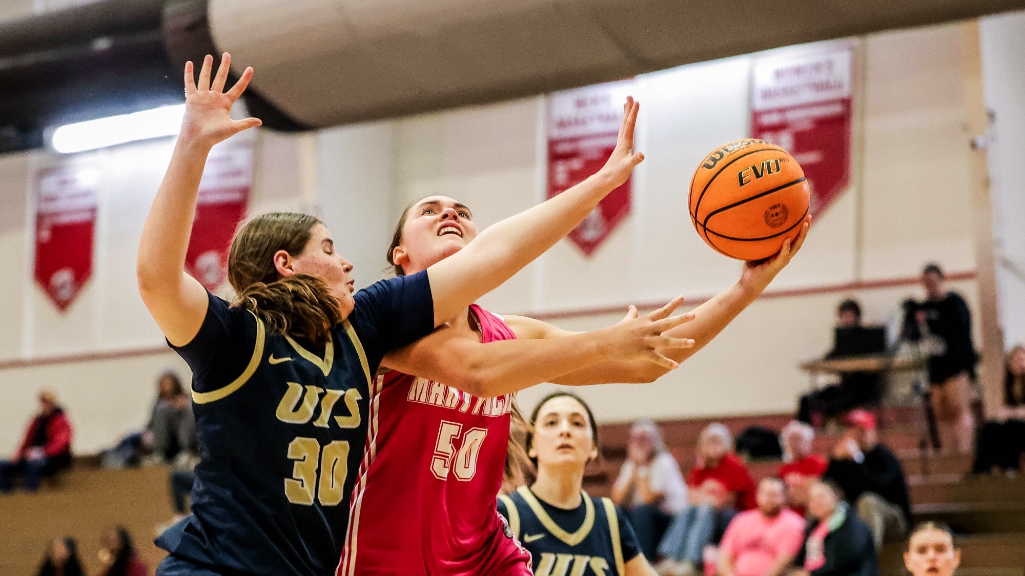 Claire Lueken with a contested layup
