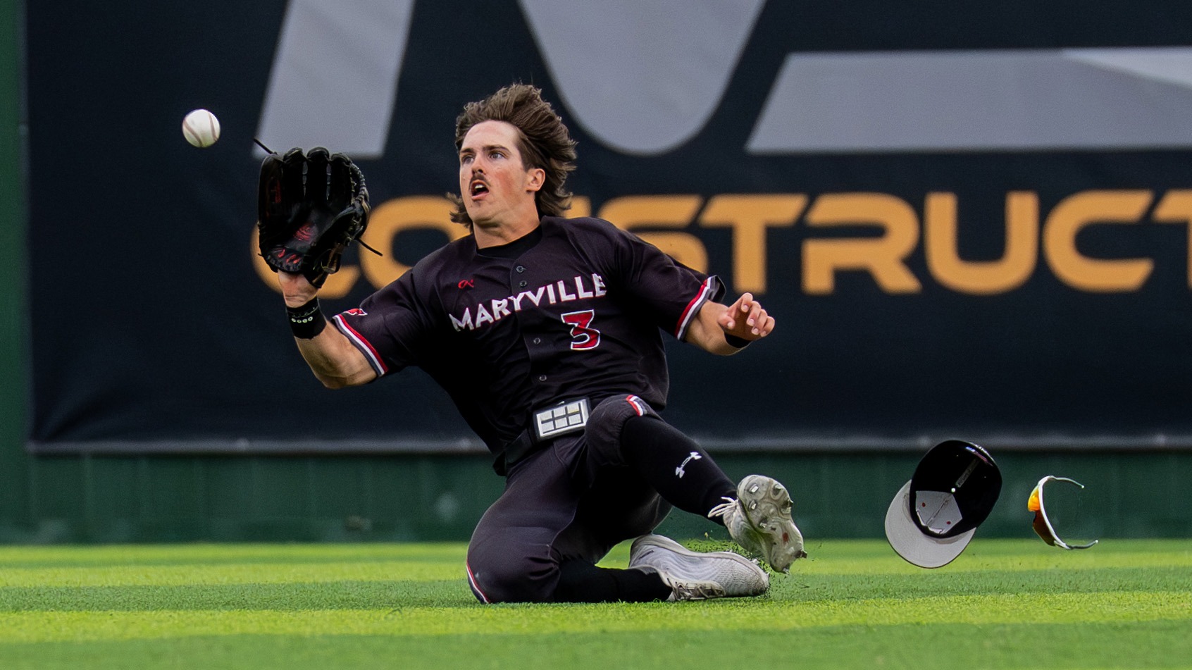 Steven Schneider slides for a ball in Centerfield